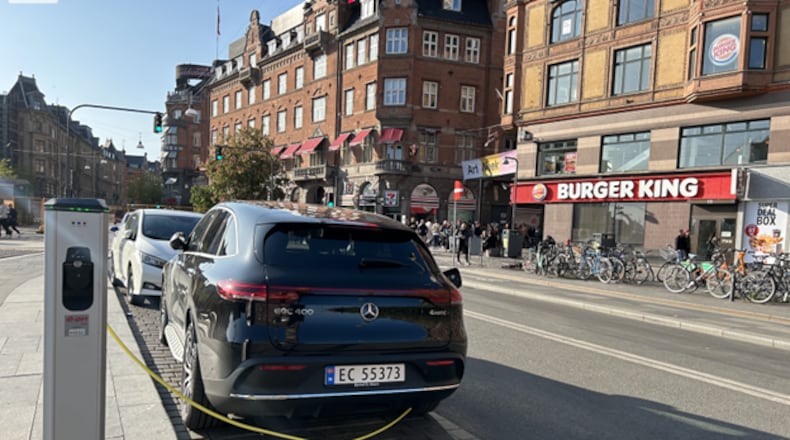 Taxi drivers charging their EVs on the streets of Copenhagen say it takes one hour for a full charge. They’ve noticed customers often ask for rides in electric vehicles. (Photo/Ralitsa Vassileva) 
.