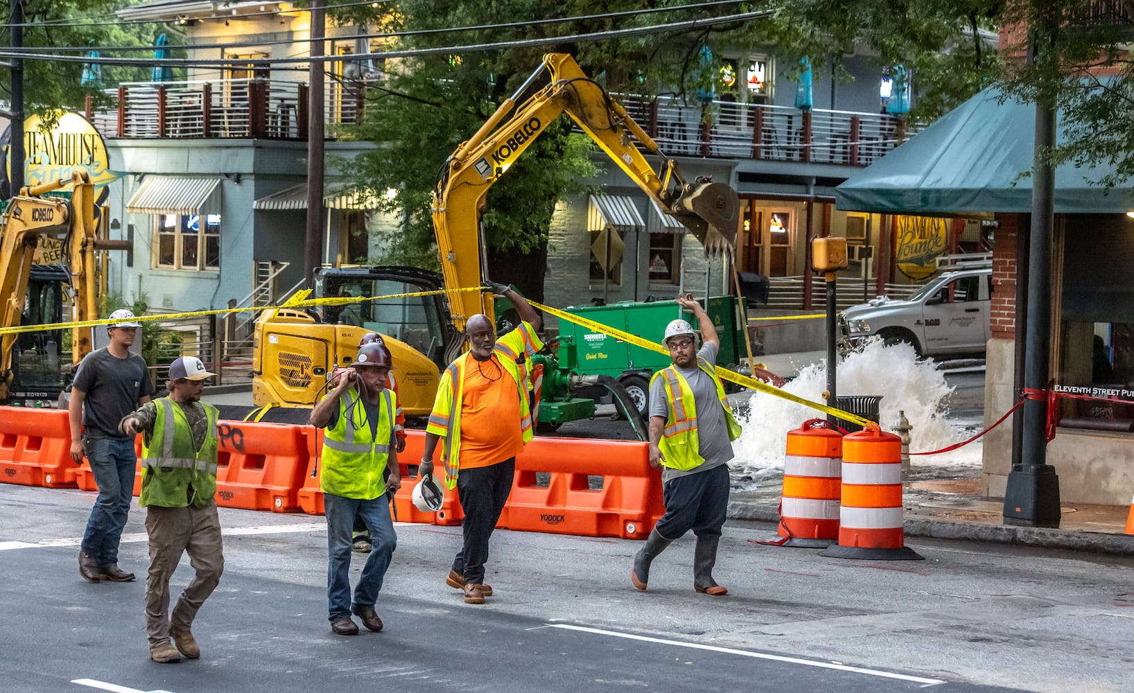 Crews are continuing to work on a broken main on West Peachtree Street at 11th Street in Midtown, with nearby residents warned of impacts to their water service as the crisis reached its fourth day Monday, June 3, 2024. Water had been gushing out of the broken main until Monday morning, when workers were seen pumping out water. (John Spink/AJC)