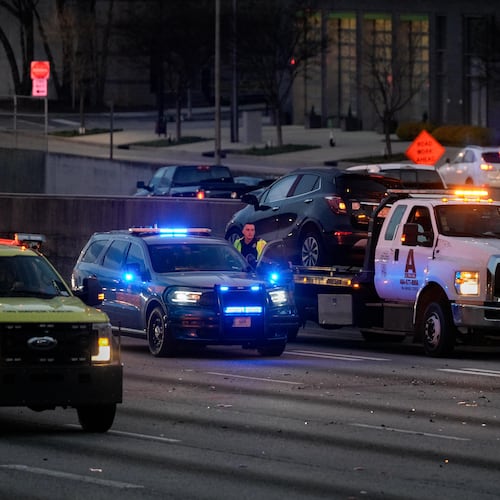 A Georgia Department of Transportation Highway Emergency Response Operators unit blocks traffic on the Downtown Connector after an early morning accident shut down the interstate for multiple hours on Friday, March 7, 2025. (Ben Hendren for the AJC)