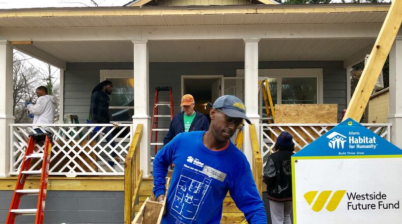 Volunteers work on a Habitat for Humanity home in the Ashview Heights neighborhood near Mercedes-Benz Stadium on Saturday, Jan. 20, 2019. J. SCOTT TRUBEY/STRUBEY@AJC.COM