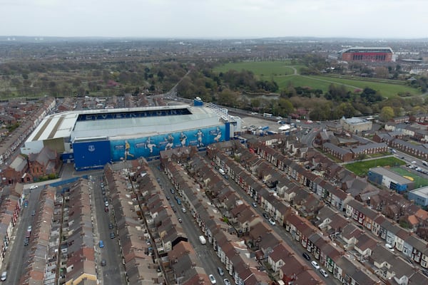 FILE - Everton's Goodison Park Stadium is seen with Liverpool's Anfield Stadium in the background, in Liverpool, England, Wednesday, April 21, 2021. (AP Photo/Jon Super, File)