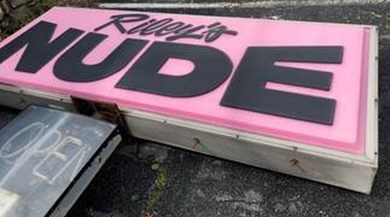 The “Riley s Nude Showbar” sign on Fulton Industrial Boulevard has been taken down in lieu of a county charge to the owners. “The Riley s signage served as an old vestige of Fulton Industrial s deterioration into a strip of cheap hotels with a high rate of prostitution and criminal activity,” the county said.