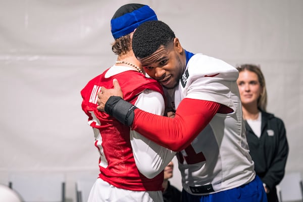 Rookie New York Giants linebacker Abdul Carter (51) and quarterback Jaxson Dart (6) embrace after their first day of the NFL football team's rookie minicamp, Friday, May 9, 2025, in East Rutherford, N.J. (AP Photo/Angelina Katsanis)