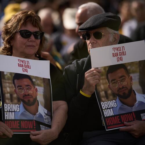 People hold signs with a photo of Ran Gvili, who was killed while fighting Hamas militants during the Oct. 7, 2023 attack and whose body has been held in Gaza ever since, during a rally calling for his return in Tel Aviv, Israel, Friday, Jan. 23, 2026. (AP Photo/Leo Correa)
