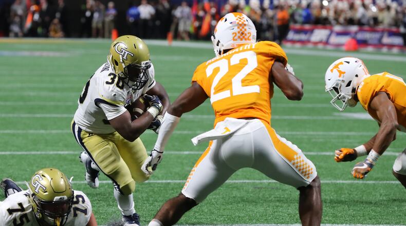 Jackets running back KirVonte Benson runs for yardage setting up a go ahead touchdown to take a 14-7 lead over Tennessee during the second quarter in a NCAA college football game on Monday, September 4, 2017, in Atlanta. Curtis Compton/ccompton@ajc.com