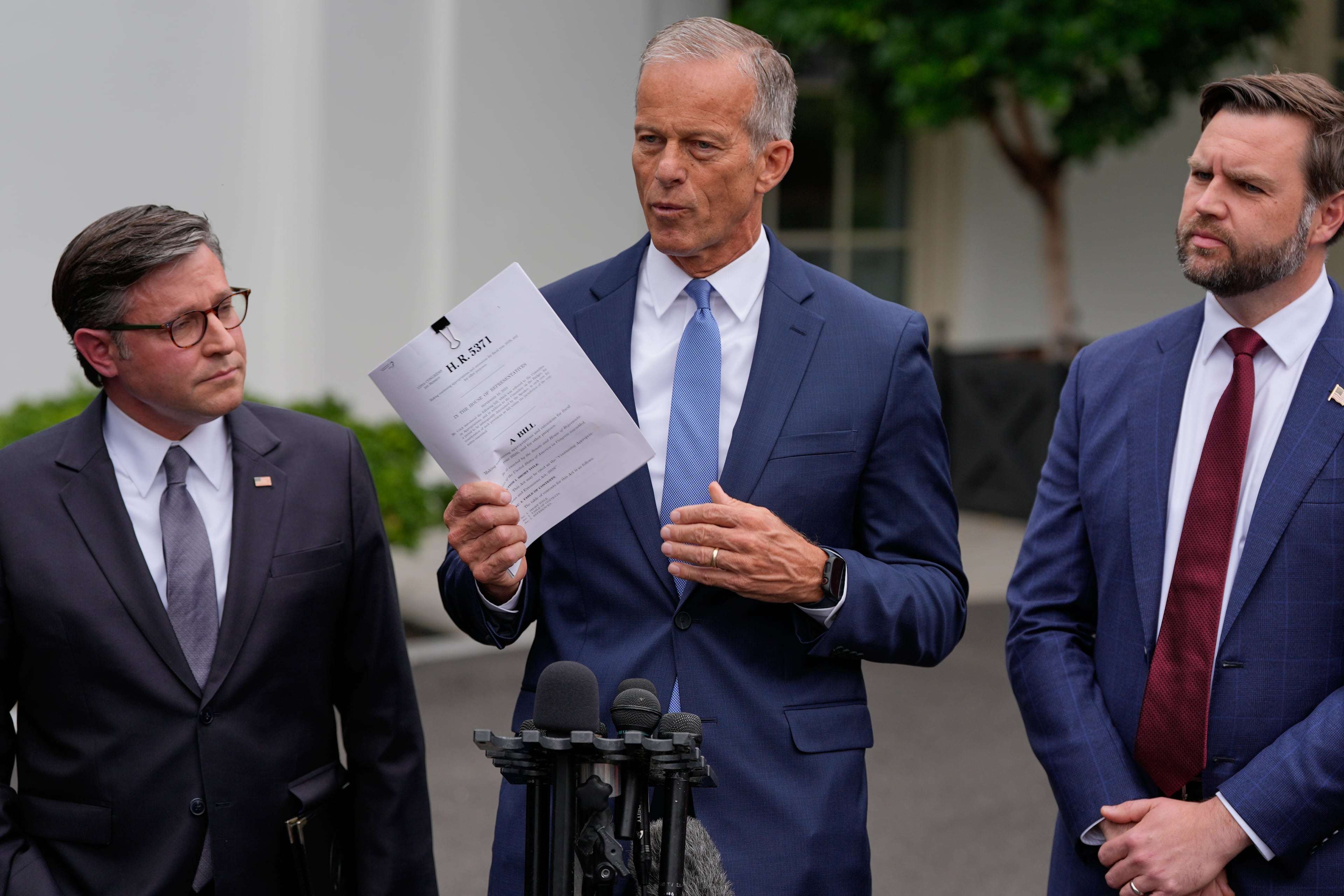 Senate Majority Leader John Thune, R-S.D., talks to reporters outside the West Wing of the White House, Monday, Sept. 29, 2025, in Washington, as House Speaker Mike Johnson, R-La., and Vice President JD Vance, listen. (Alex Brandon/AP)