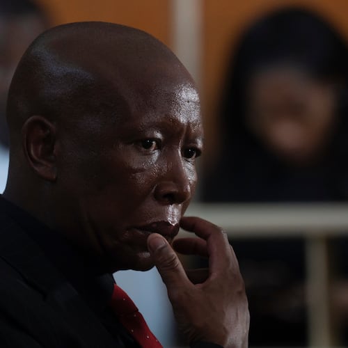 Julius Malema, leader of the Economic Freedom Fighters party, sits in a courtroom during sentencing for firing a rifle at a political rally, in East London, South Africa, Thursday, April 16, 2026. (AP Photo)