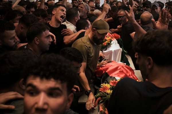 Mourners carry the bodies of Palestinian-American Sayfollah Musallet, 20, and Mohammed al-Shalabi during their funeral in the West Bank village of Al-Mazraa a-Sharqiya on Sunday, July 13, 2025. According to the Palestinian Health Ministry, Musallet was killed in an attack by Israeli settlers and al-Shalabi was shot in the chest. (AP Photo/Leo Correa)