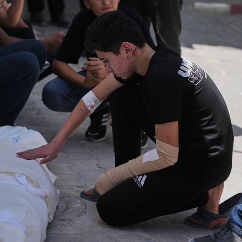 Omar Klaub, injured in an Israeli strike, mourns beside the body of his mother, Rana, who was killed in the same attack, during her funeral at Shifa Hospital in Gaza City, Thursday, June 4, 2026. (AP Photo/Jehad Alshrafi)