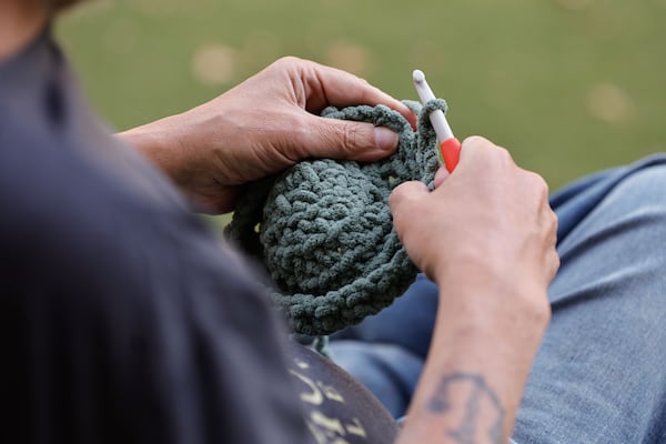 Penn Collins said he taught himself to crochet by watching videos on YouTube. (Natrice Miller/AJC)