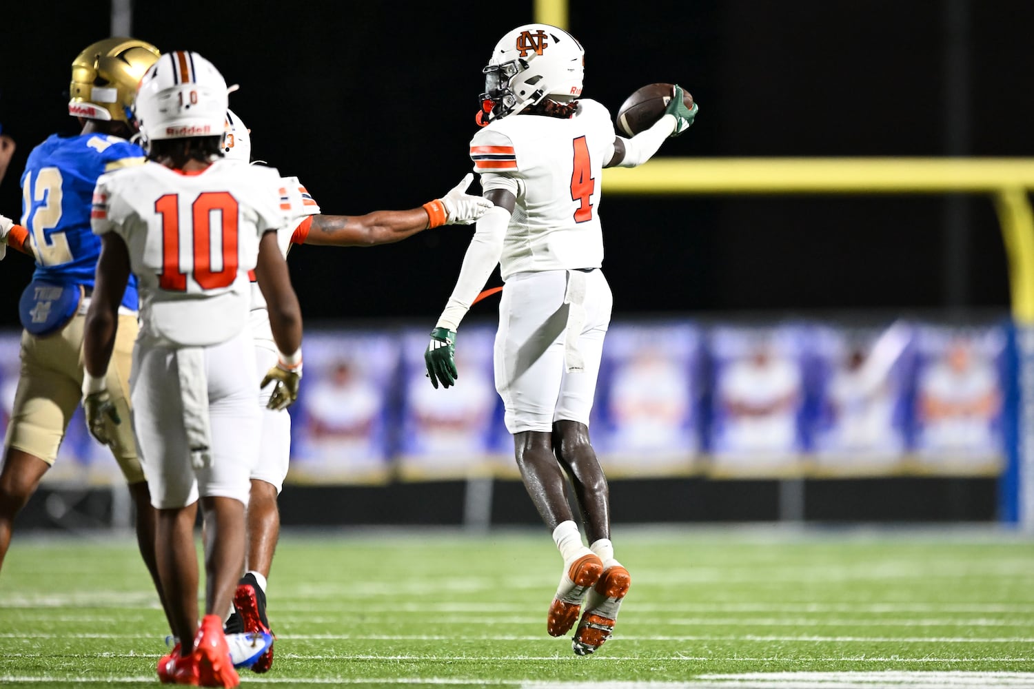 North Cobb cornerback Keshawn Alexis (4) recovers a McEachern fumble and runs for a short gain in yardage during the second half of play Friday, August 22, 2025 at McEachern.  (Daniel Varnado/For the Atlanta Journal-Constitution)