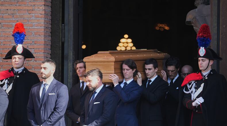 The casket of fashion designer Valentino Garavani leaves the St. Mary of Angels Basilica at the end of his funeral, in Rome, Friday, Jan. 23, 2026. (AP Photo/Andrew Medichini)