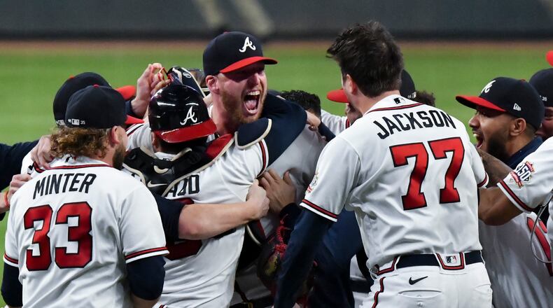 The Atlanta Braves celebrate a series-clinching 5-4 win against the Milwaukee Brewers in Game 4 of the National League Division Series at Truist Park in Atlanta on Tuesday, Oct. 12, 2021. (Hyosub Shin/Atlanta Journal-Constitution/TNS)