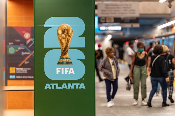 MARTA riders walk past a FIFA World Cup poster inside the Five Points MARTA station on Friday, June 5, 2026. (Ben Hendren for the AJC)
