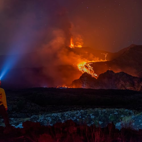 Eruptive activity continues on Mount Etna, where lava flows continue to descend on the slopes of the volcano, as seen from Mareneve near Catania, Italy, Thursday, Aug. 13, 2026. (AP Photo/Salvatore Allegra)