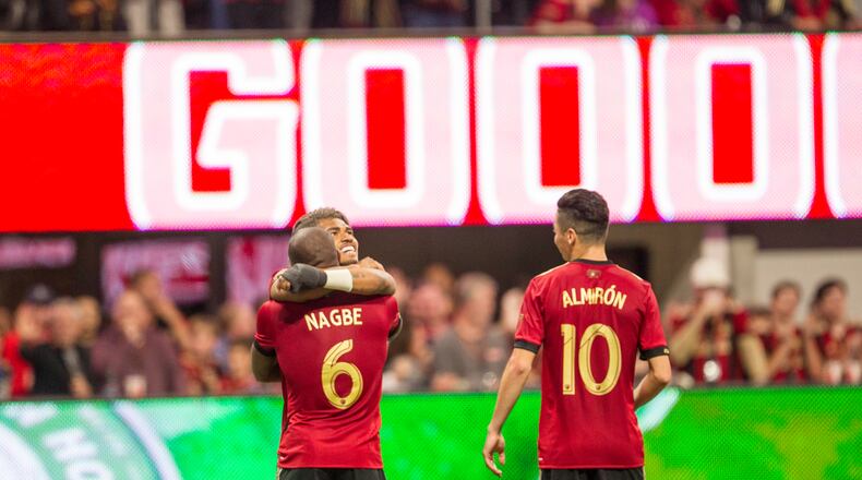 Atlanta United forward Josef Martinez (7) hugs Atlanta United midfielder Darlington Nagbe (6) after Nagbe makes a goal during the match between NYC FC and Atlanta United at Mercedes-Benz Stadium in Atlanta, Georgia, on Sunday, April 15, 2018. The goal was later taken away due to a penalty. (REANN HUBER/REANN.HUBER@AJC.COM)