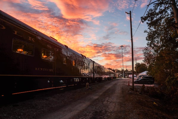 The sun sets over the train during Tracks of Hope event, Nov. 13 in Forest Park. (Abbey Cutrer/AJC)