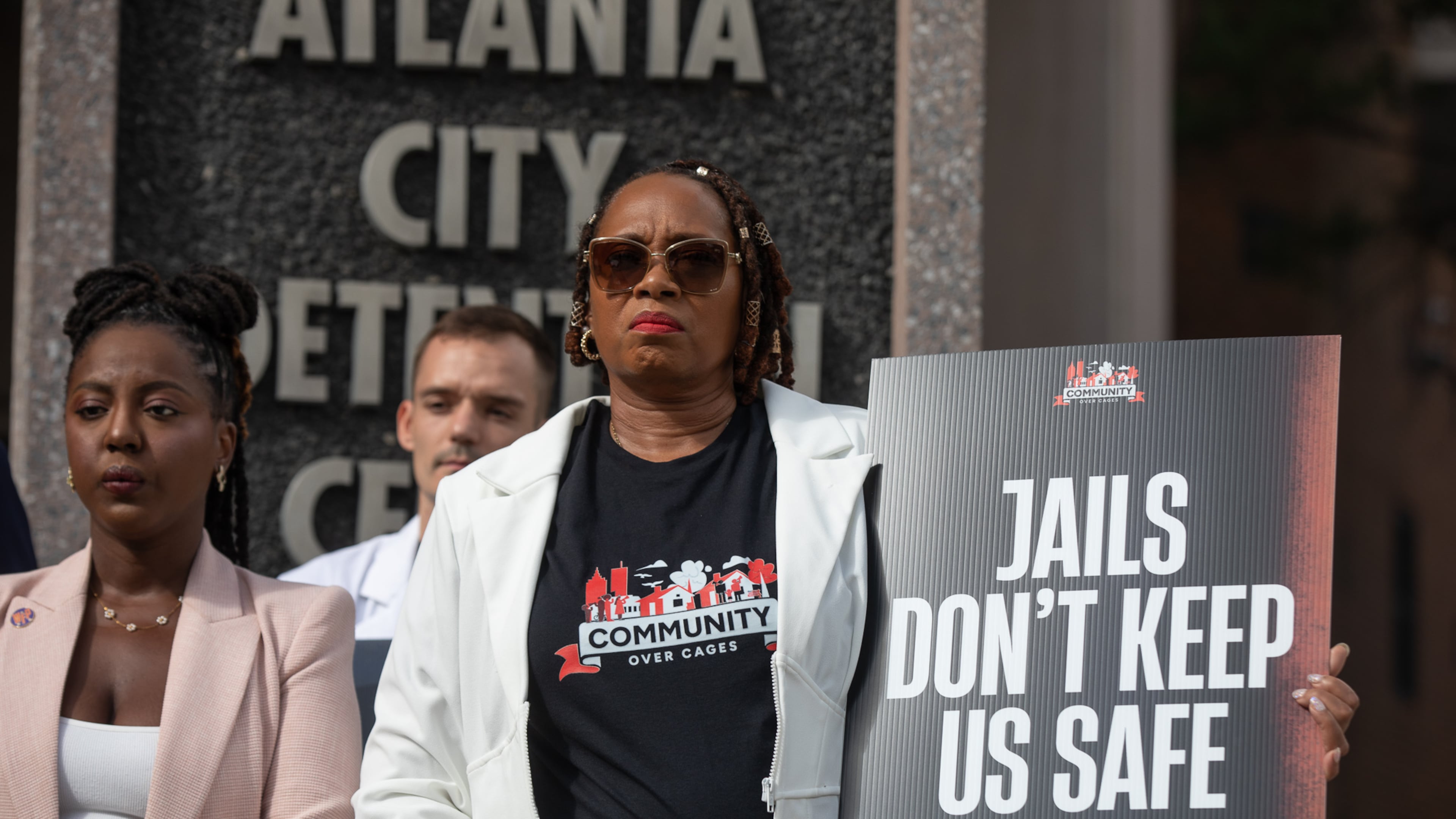 Roberta Meyers, with the Legal Action Center, joins advocates outside of the Atlanta City Detention Center on Aug. 13, 2025, to call for city officials to begin planning the withdrawal of Fulton County inmates from the jail. (Riley Bunch/AJC)