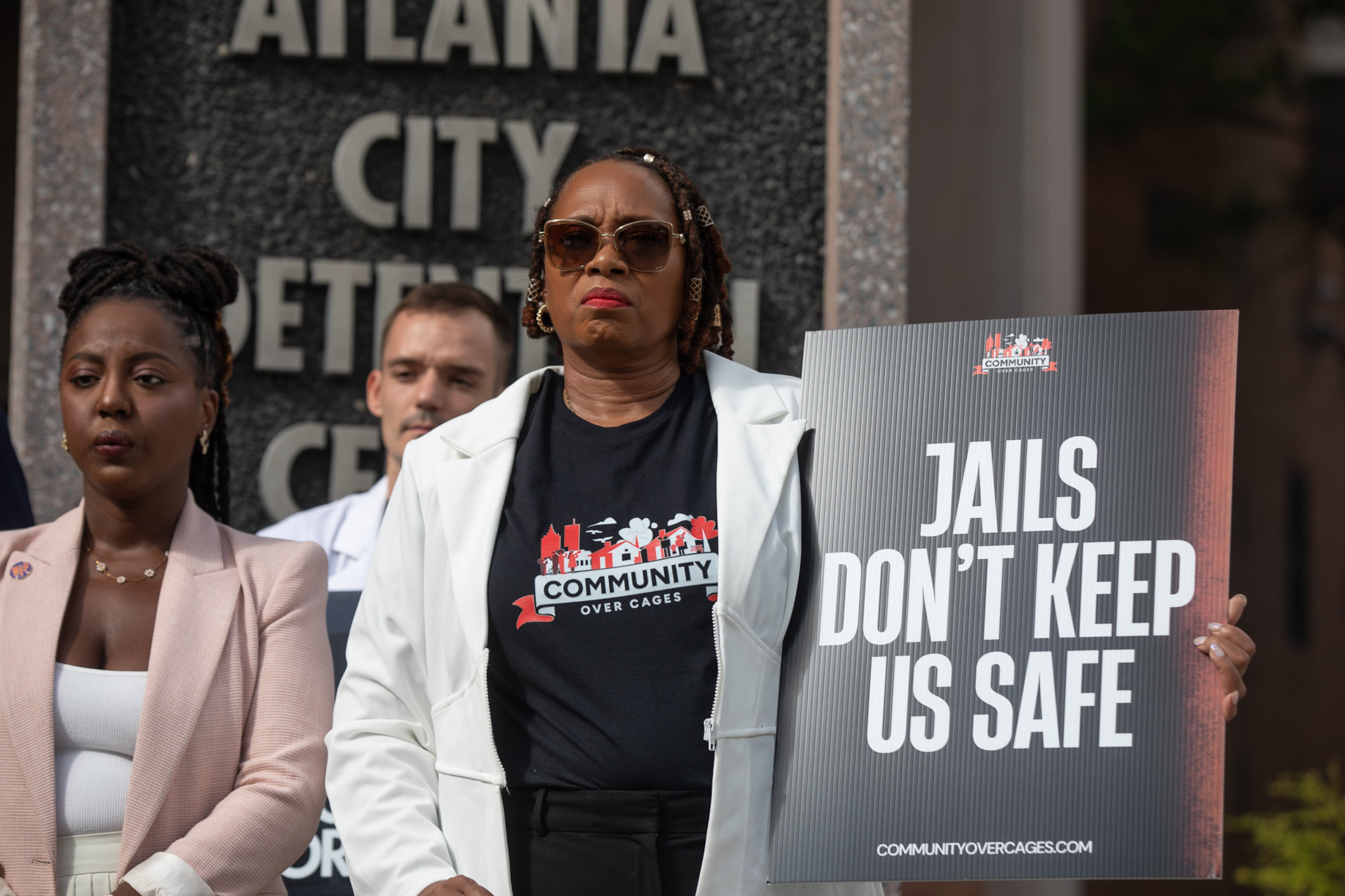 Activists, including Roberta Meyers (center) of the Legal Action Center, demonstrated on Aug. 13, 2025, calling for city officials to begin planning the withdrawal of Fulton County inmates from the Atlanta City Detention Center. (Riley Bunch/AJC)