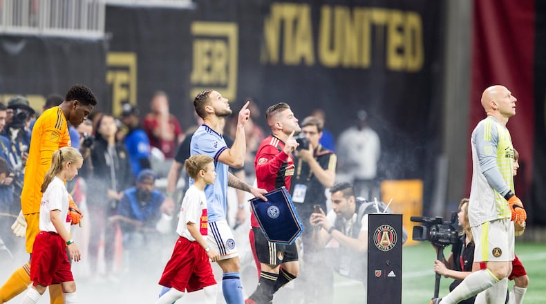 Atlanta United and NYC FC players walk onto the field together before the match between NYC FC and Atlanta United at Mercedes-Benz Stadium in Atlanta, Georgia, on Sunday, April 15, 2018. (REANN HUBER/REANN.HUBER@AJC.COM)