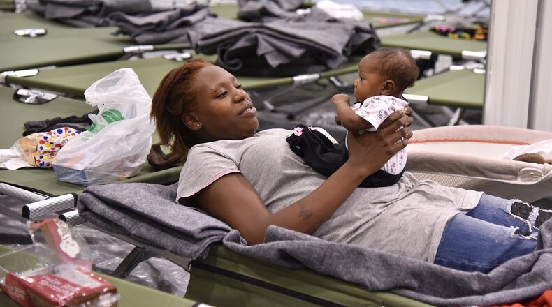 Markita Riley and her 2-month-old daughter Amaris from Brunswick, Ga., prepare to spend the night in a Red Cross shelter in Macon on Friday, Oct. 7, 2016, as Hurricane Matthew hits the coast. BRANT SANDERLIN/BSANDERLIN@AJC.COM