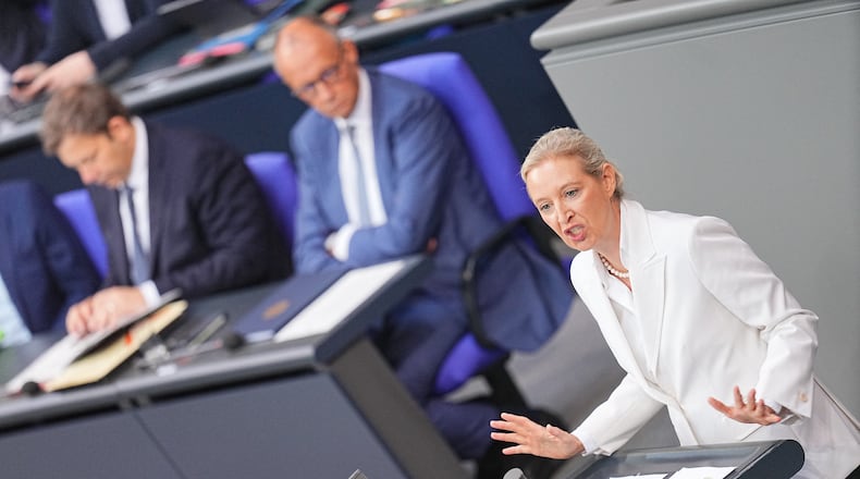 Federal chairwoman and parliamentary group leader of the AfD Alice Weidel opens the general debate as part of the budget deliberations in the Bundestag, with German Chancellor Friedrich Merz sitting on the background, in Berlin, Wednesday Sept. 9, 2026 (Michael Kappeler/dpa via AP)