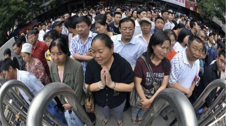 Chinese parents wait for their children taking part in the national college entrance exams. China's annual college entrance exams are intensely competitive as paper qualifications can mean the difference between unemployment and a high paying job.
