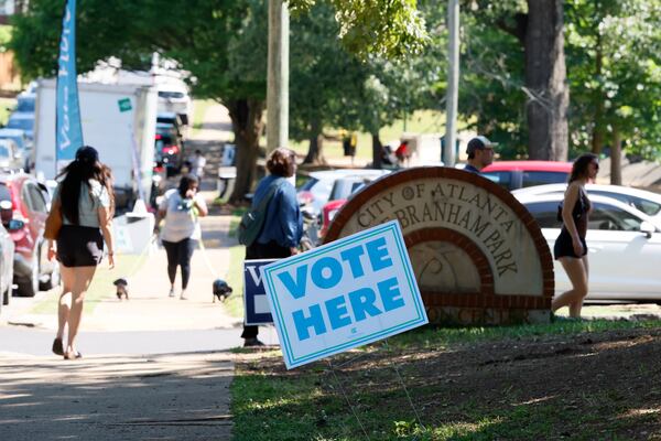 People are seen walking toward Bessie Branham Recreation Center in Kirkwood on Friday during the final day of early voting before the midterm primary elections. (Miguel Martinez/AJC)
