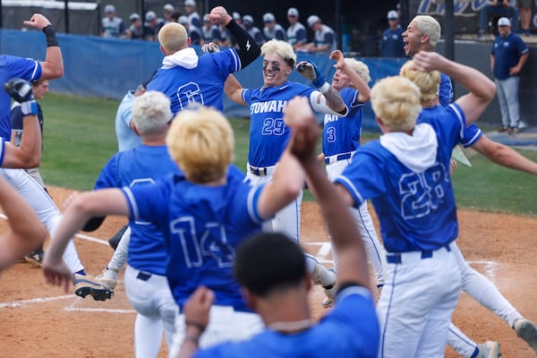 Etowah High School baseball players celebrate during a recent playoff game against Harrison. (Arvin Temkar/AJC)