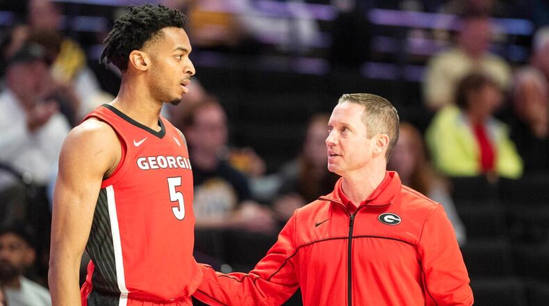 Georgia head coach Mike White, right, speaks with center Frank Anselem (5) in the first half of an NCAA college basketball game against Wake Forest, Friday, Nov. 11, 2022, in Winston-Salem, N.C. (Allison Lee Isley/The Winston-Salem Journal via AP)