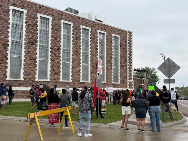 Protestors gather outside the South Dakota State Penitentiary on Friday, May 23, 2025 to protest about recent prison deaths. (AP Photo/Sarah Raza)