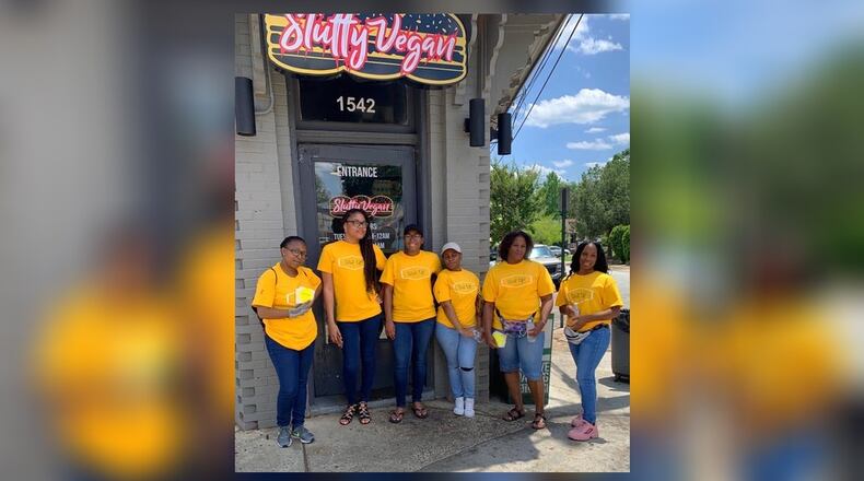 Wait Up! team members pose during their launch day in front of Slutty Vegan in Atlanta on Saturday, June 1, 2019.