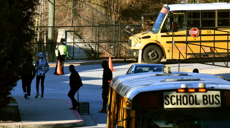 Students are dropped off at Crawford W. Long Middle School Wednesday morning, January 26, 2022. The Environmental Protection Agency issued an emergency order involving an Atlanta metal processing facility, citing the “imminent and substantial endangerment” its hazardous waste releases may pose to the public and the environment. The facility, run by TAV Holdings Inc., backs up to Crawford W. Long Middle School in the Glenrose Heights neighborhood in south Atlanta. (Hyosub Shin / Hyosub.Shin@ajc.com)