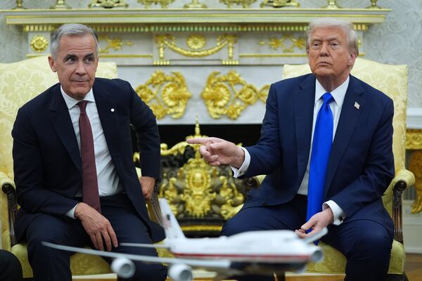 President Donald Trump (right) gestures alongside Canadian Prime Minister Mark Carney as they meet in the Oval Office of the White House in October. (Evan Vucci/AP)