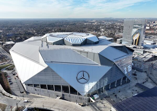 Aerial photo shows the Mercedes-Benz Stadium and Signia by Hilton Atlanta Georgia World Congress Center decorated with College Football Championship logos ahead of the 2025 College Football National Championship between Notre Dame and Ohio State, Friday, January 17, 2025, in Atlanta. (Hyosub Shin/AJC)