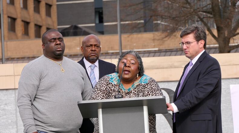 Julian Lewis' widow, Betty Lewis (center), speaks about the death of her late husband. She was flanked Friday by her son Eric Clay (left) and the family's attorneys, Andrew Lampros (right) and Akil Secret. (Courtesy of Diane Crow Photography)