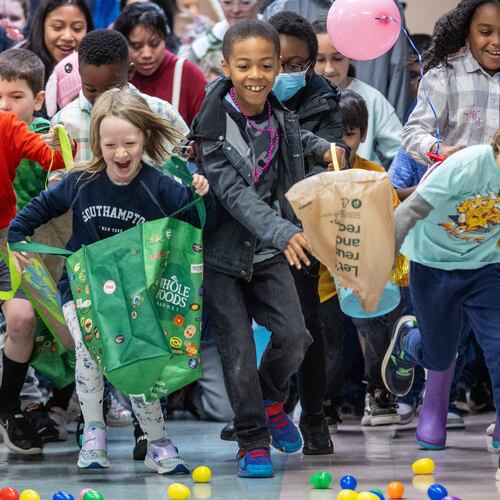 Kids race to gather eggs at the Mason Mill Park and Bridgepoint Church during an indoor Easter egg hunt in April 2023. The event was moved inside because of rain that year. The forecast calls for another wet holiday this year. (Steve Schaefer/AJC 2023)