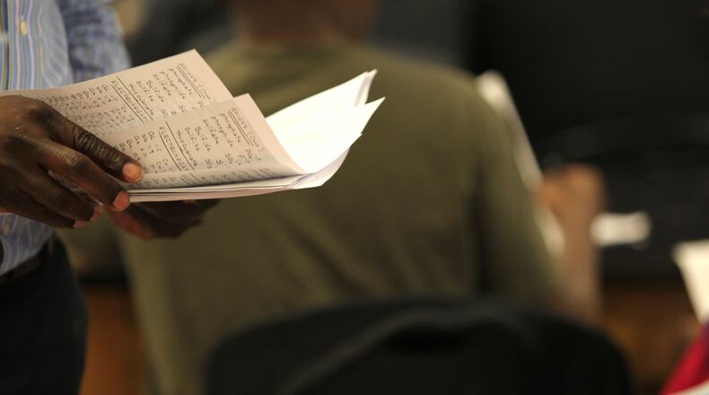 Chemistry teacher Ronald Saint-Preux passes out a periodic table with additional information on it that his students can use on their test at Dunwoody High School. . TAYLOR CARPENTER / TAYLOR.CARPENTER@AJC.COM