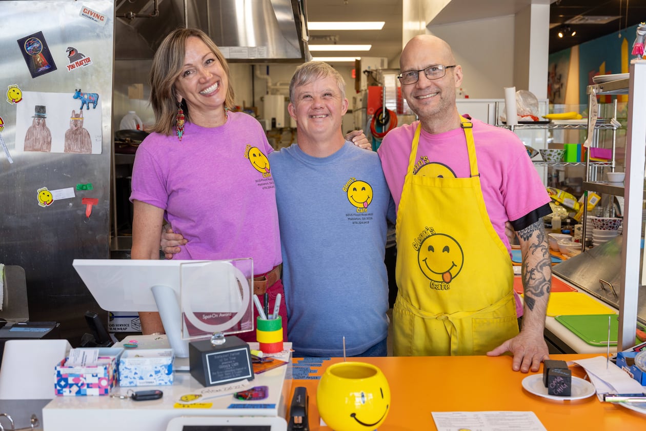 Patricia Walesh (from left), Glenn Hutchinson and Jason Walesh pose in Glenn's Cafe in Mableton. The Waleshes started the cafe to help people with disabilities have jobs and also to raise awareness about special needs people in the community. The cafe was named after Jason's brother, Glenn Hutchinson, who serves as guest relations specialist. (Phil Skinner for the AJC)