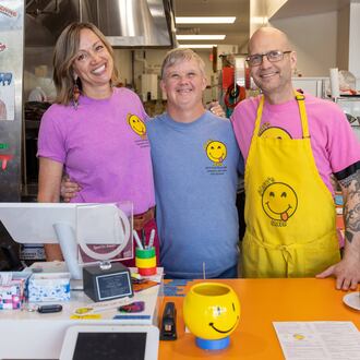 Patricia Walesh (from left), Glenn Hutchinson and Jason Walesh pose in Glenn's Cafe in Mableton. The Waleshes started the cafe to help people with disabilities have jobs and also to raise awareness about special needs people in the community. The cafe was named after Jason's brother, Glenn Hutchinson, who serves as guest relations specialist. (Phil Skinner for the AJC)