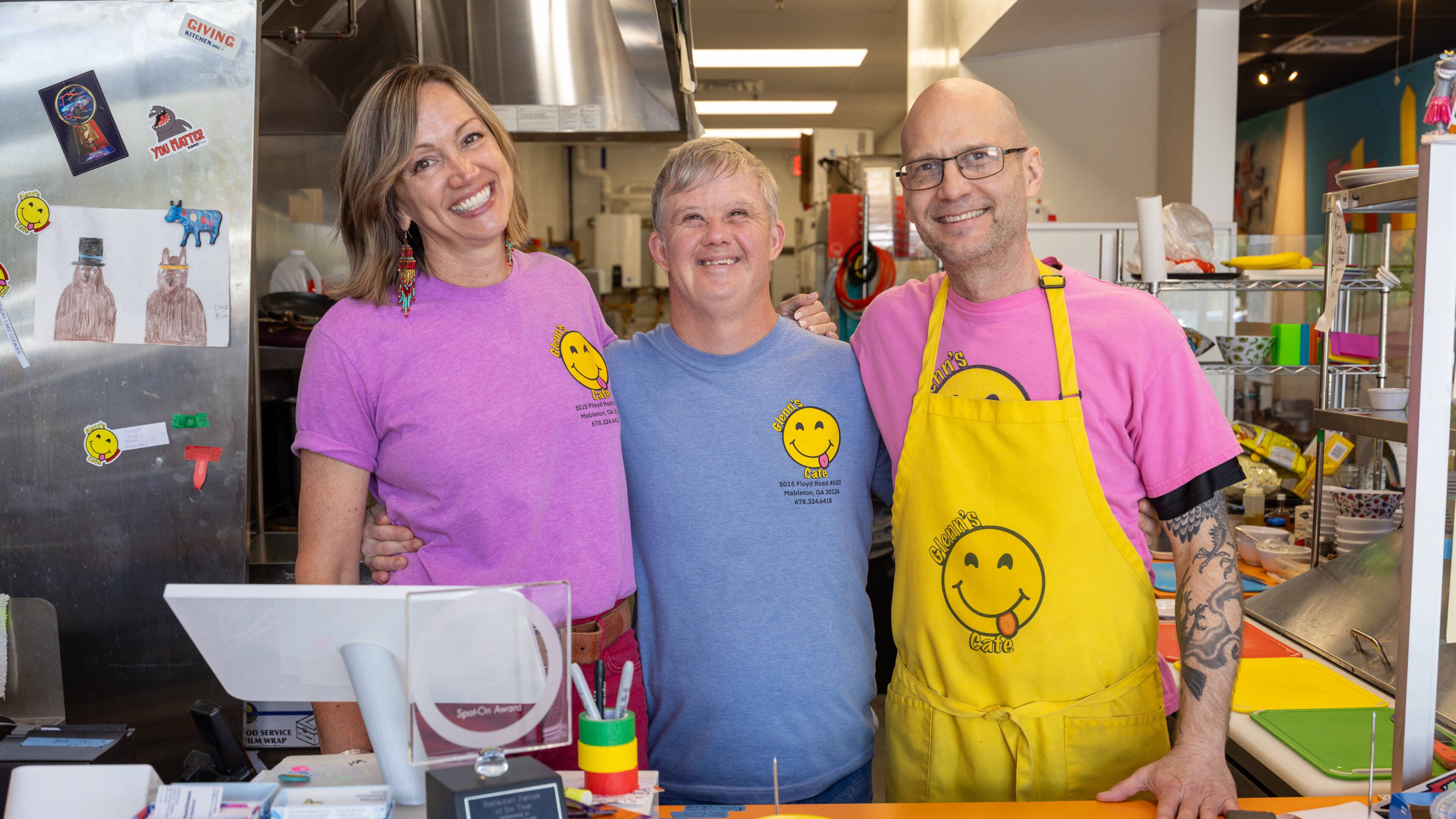 Patricia Walesh (from left), Glenn Hutchinson and Jason Walesh pose in Glenn's Cafe in Mableton. The Waleshes started the cafe to help people with disabilities have jobs and also to raise awareness about special needs people in the community. The cafe was named after Jason's brother, Glenn Hutchinson, who serves as guest relations specialist. (Phil Skinner for the AJC)
