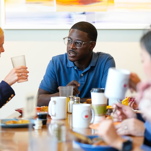Democratic gubernatorial nominee David Crowley, right, talks with lieutenant governor nominee Sarah Godlewski, left, while at breakfast with Democratic leaders at Prairie Cafe and Bakery Wednesday, Aug. 12, 2026, in Middleton, Wis. (AP Photo/Kayla Wolf)