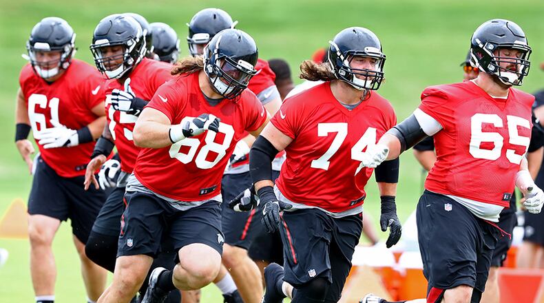 Atlanta Falcons offensive lineman Austin Pasztor (from left), Ty Sambrailo, and Brandon Fusco run an agility drill during team practice on Tuesday, June 5, 2018, in Flowery Branch.