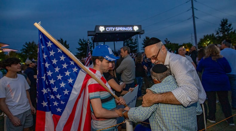 Thousands of Israel supporters, including Yosef Fried, from left, Yosef Ovadia and Yisrael Herscovici of Beth Jacob gather inside and outside of City Springs in Sandy Spring on Tuesday, Oct 10, 2023 for a rally for Israel. (Jenni Girtman for The Atlanta Journal-Constitution)