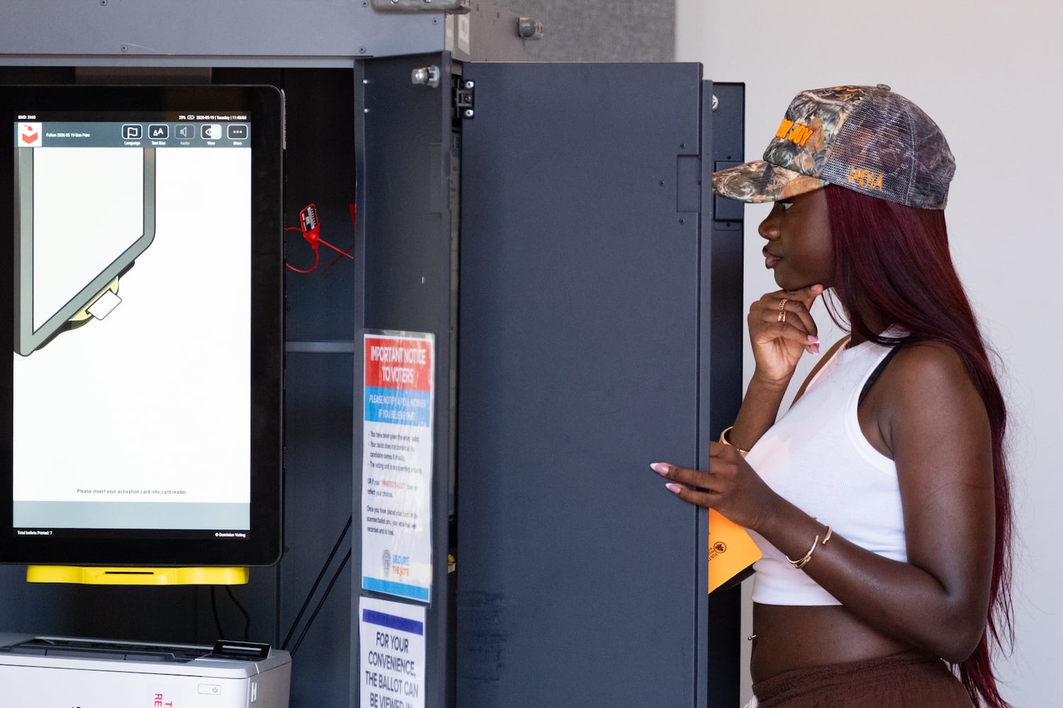 Selah Quadjovie studies the ballot while voting at Friendship Community Church in South Fulton on Tuesday, May 19, 2026. (Ben Gray for the AJC)