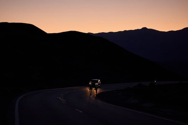 Danny Westergaard, left, competes with pacing help from daughter Madison Westergaard as the sun rises during the Badwater 135 Ultramarathon, Tuesday, July 8, 2025, in Death Valley National Park, Calif. (AP Photo/John Locher)