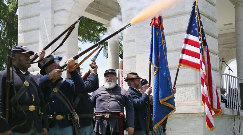 A musket salute by Elias Moon Camp #2 followed the laying of the wreaths during 2013’s Memorial Day ceremony at Marietta National Cemetery. A few days ahead of the event, which will be at noon May 25 this year, area Boy Scouts, Cub Scouts, Girl Scouts and Brownies place flags on every grave. BOB ANDRES / BANDRES@AJC.COM