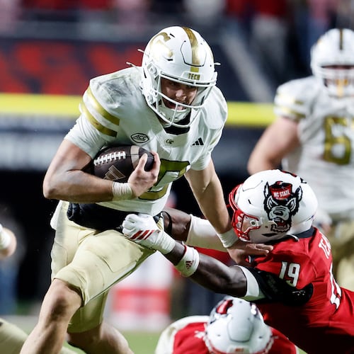 Georgia Tech quarterback Haynes King (10) tries to break away from North Carolina State safety Tristan Teasdell (19) during the second half of an NCAA college football game in Raleigh, N.C., Saturday, Nov. 1, 2025. (AP Photo/Karl DeBlaker)