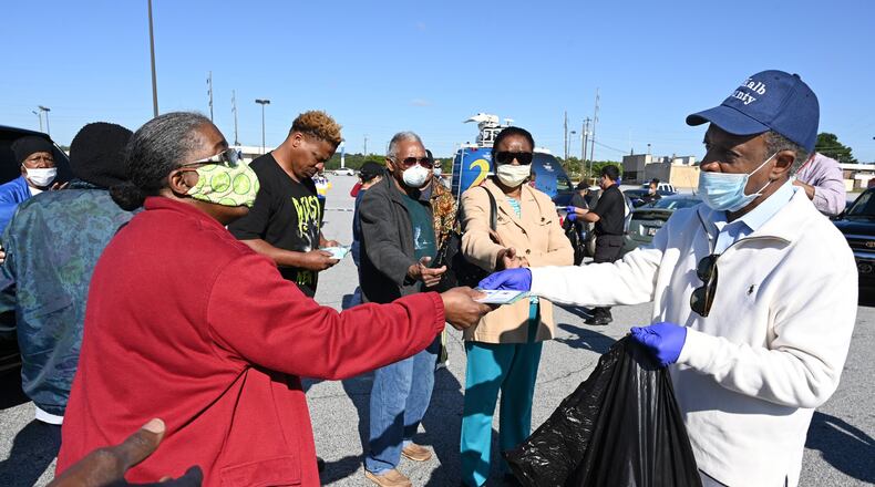 DeKalb County CEO Michael Thurmond hands COVID-19 care kits out to residents at Big Lots parking lot at 2738 Candler Road in Decatur on Saturday, May 9, 2020. (Hyosub Shin / Hyosub.Shin@ajc.com)