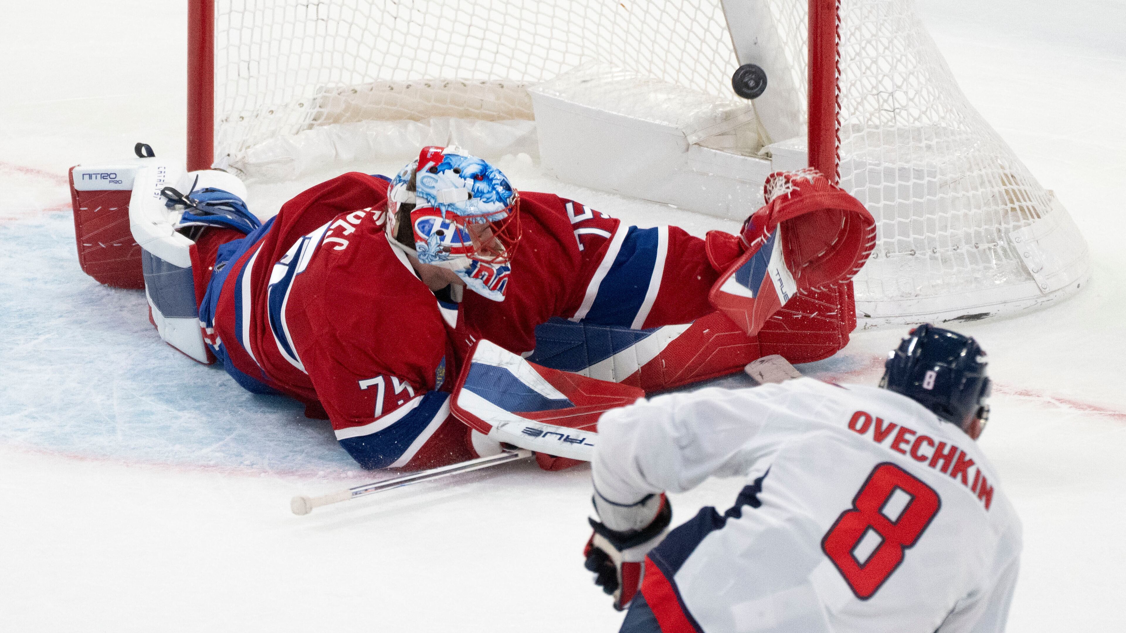 Washington Capitals' Alex Ovechkin (8) scores against Montreal Canadiens goaltender Jakub Dobes (75) during third-period NHL hockey game action in Montreal, Thursday, Nov. 20, 2025. (Christinne Muschi/The Canadian Press via AP)